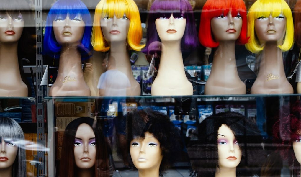 a bunch of wigs that are on display