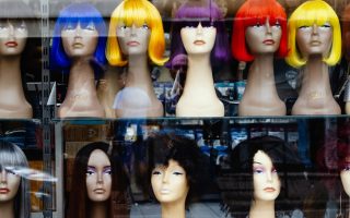 a bunch of wigs that are on display